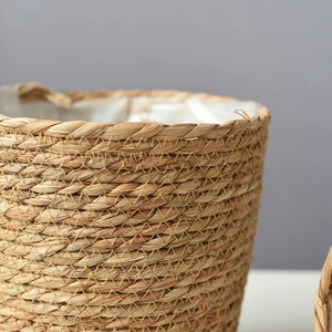 Macro shot of hand-woven seagrass planter basket with waterproof plastic lining and thick weave