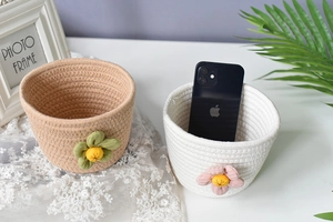 Detailed close-up of woven cotton rope storage baskets with cute sunflower decorations