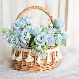 Detail of round woven basket with white lace fringe and light blue silk roses decoration