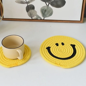 Japanese style yellow cotton woven coasters with smiling face pattern for table decor
