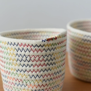 Detailed close-up of thick cotton rope weave with colorful zigzag stitching on a basket