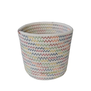 Minimalist white cotton rope woven storage basket with colorful zigzag stitching patterns