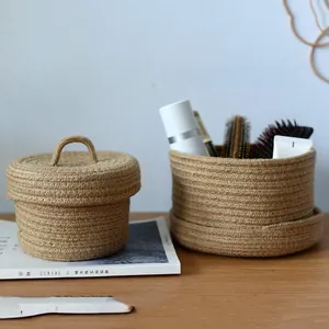 Detail view of handmade jute woven baskets for cosmetic storage on a wooden table