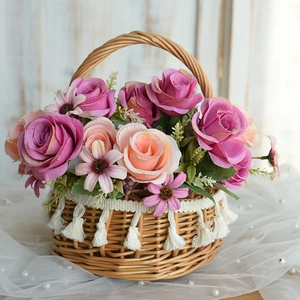 Detail of woven rattan flower basket featuring white fringe and realistic faux roses