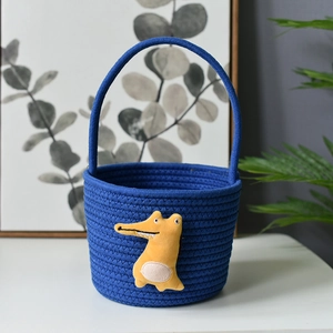 Detailed view of royal blue woven cotton storage basket with yellow crocodile decor
