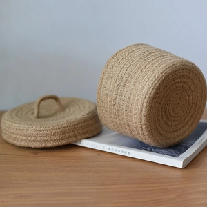 Detail of hand-woven jute storage basket featuring a textured lid and natural fiber finish