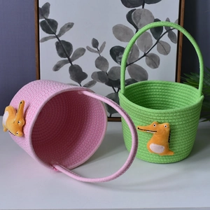 Detail of pink and green cotton rope woven baskets with cute yellow alligator decor