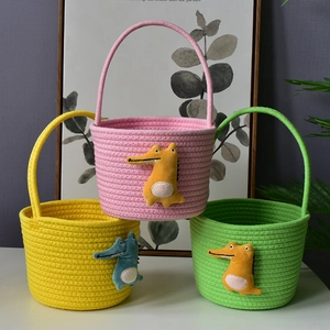 Detailed view of woven cotton gift baskets with cute plush crocodile decor in three colors