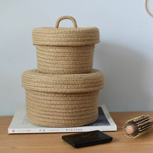 Detail showing two-piece woven storage baskets with lids and handles in home setting