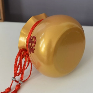 Nahaufnahme des goldenen Fu-Blumeneimers mit roter Quaste und chinesischem Fu-Zeichen