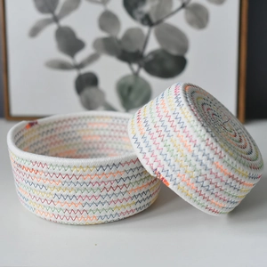 Set of two round white cotton rope storage baskets with colorful stitching for organization