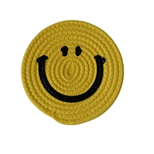 Handwoven yellow cotton rope coaster with a minimalist black smiley face design