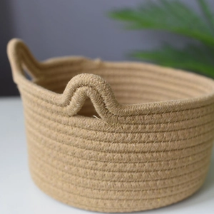 Handwoven cotton rope storage basket with round handles for desktop organizing