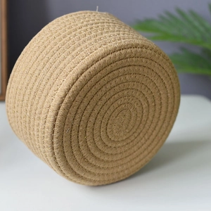 Macro detail of hand-woven cotton rope storage basket with spiral braided texture