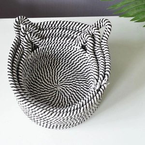 Three-piece nesting woven cotton rope storage baskets with black and white spiral design