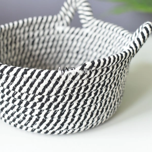 Close-up of woven cotton rope storage basket with black and white diagonal stripe texture