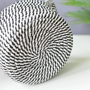 Detailed macro view of the black and white spiral woven cotton rope storage basket