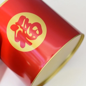 Detailed close-up of a red metal flower bucket with a golden Fu character design
