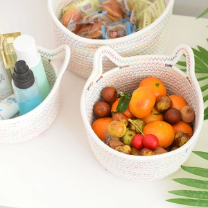 Close-up of hand-woven cotton rope storage basket with cute cat ear design and stitching