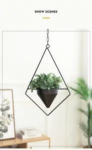 Modern black geometric metal hanging planter with artificial green plants for home decor