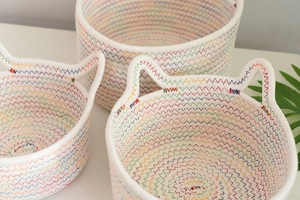 Detailed close-up of woven cotton rope baskets featuring rainbow stitching and cute cat ears