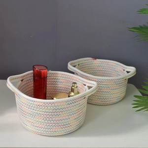 Pair of woven cotton rope storage baskets with colorful wavy stitching and handles