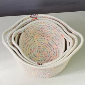Detailed macro view of nesting cotton rope baskets with colorful zigzag stitching patterns