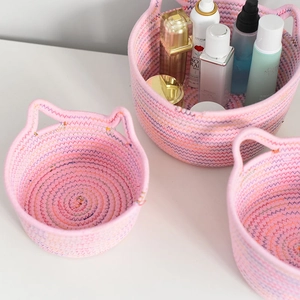 Detail showing pink cotton rope woven basket with cute cat ear handles for home storage