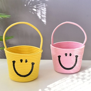 Set of two cotton rope storage baskets with smiley faces in yellow and pink colors