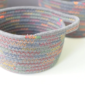 Close-up of woven cotton storage basket featuring vibrant rainbow stitching details