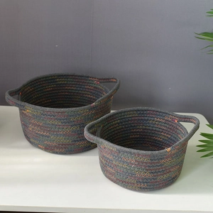 Detailed view of woven cotton rope baskets with colorful stitching and dual handles