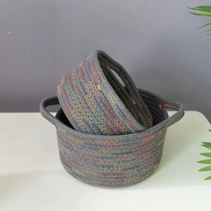 Detail of woven cotton storage baskets featuring multi-color stitching and built-in handles