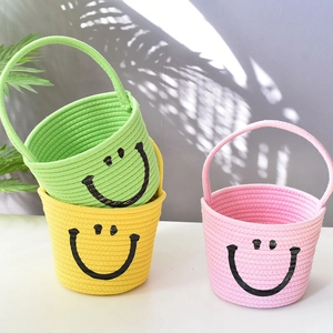 Three colorful woven cotton rope baskets with smiley faces and convenient handles