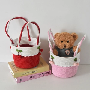 Detail of handwoven cotton baskets with cherry decor and stylish braided handles