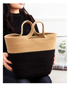 Detail of hand-woven two-tone cotton rope tote bag with sturdy handles and contrast design
