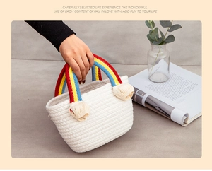 Close-up of a white woven cotton rope bag featuring a vibrant rainbow handle and soft tassels
