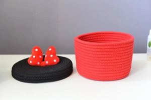 Detail of red and black woven cotton storage basket with Minnie style polka dot bow