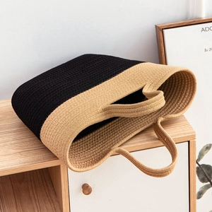 Minimalist hand-woven color block straw tote bag for beach vacation in black and khaki