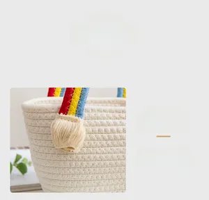 Close-up of hand-woven cotton rope bag featuring colorful rainbow tassels and fine texture