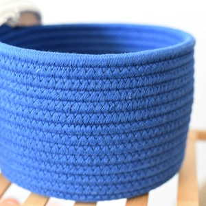 Close-up of dark blue woven cotton rope storage basket showing detailed spiral texture