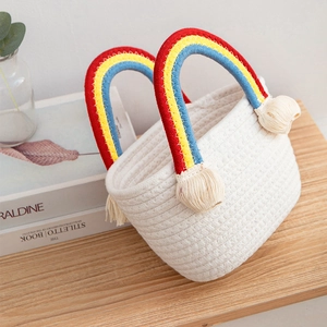 White woven cotton rope beach bag with colorful rainbow handles and tassel details