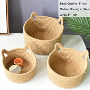 Detailed view of three sizes woven cotton rope storage baskets with cute cat ear handles