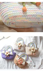 Detailed close-up of rainbow handle and fabric flower on handwoven mini cotton bag
