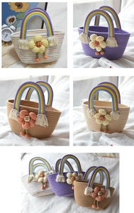 Detail of handmade cotton rope bucket bag featuring rainbow handle and 3D floral accent