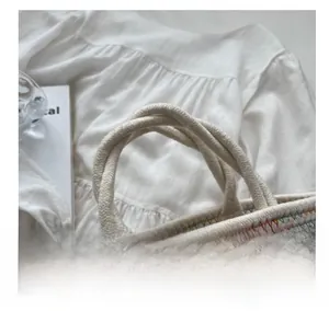 Detail of the handmade woven tote bag with colorful stitching and soft cotton rope handle