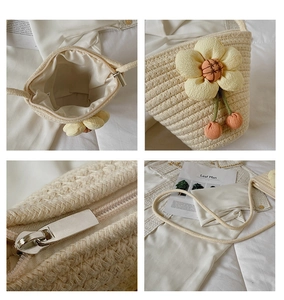 Detailed close-up of woven bucket bag featuring floral decor and metal zipper closure