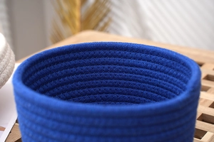 Close-up of royal blue woven cotton rope storage basket with spiral braided texture