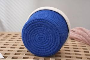 Close-up of the woven cotton rope texture and navy blue color block on storage basket