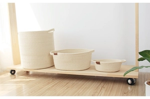 Three-piece set of woven cotton rope storage baskets with leather labels and handles