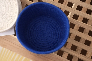 Top view of deep blue woven storage basket with spiral cotton rope texture and round design